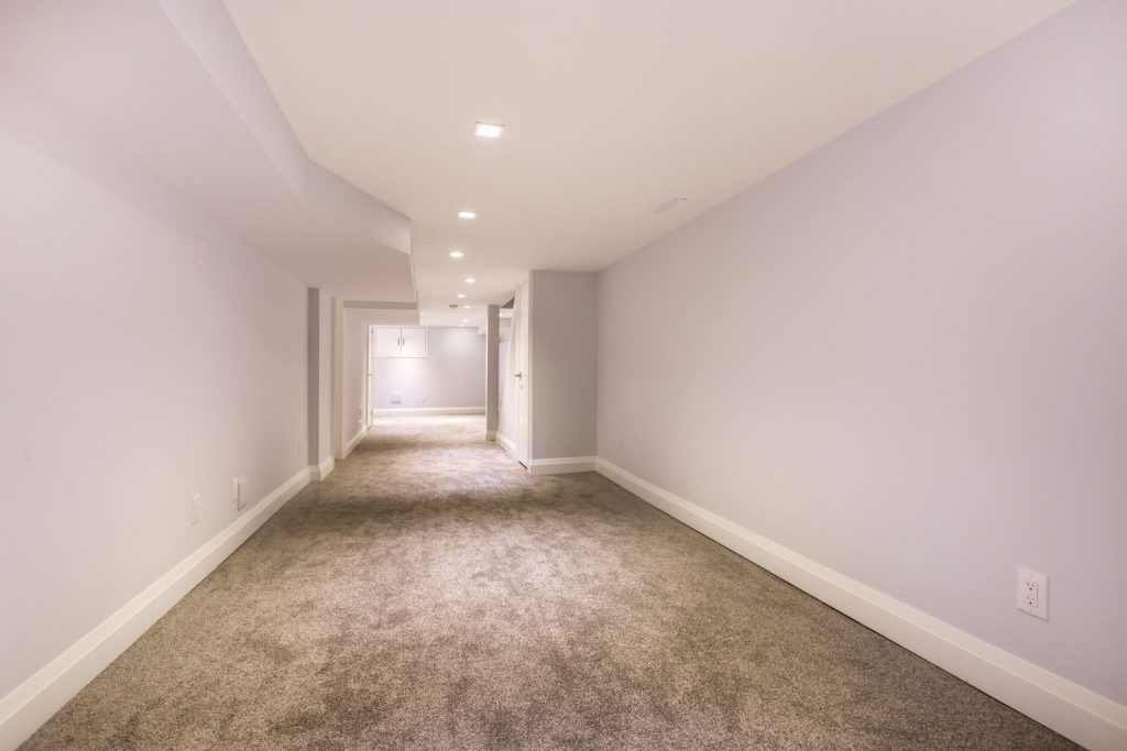 Finished renovation to a residential basement in Toronto by Focus Construction. Neutral walls and flooring with square inset lights
