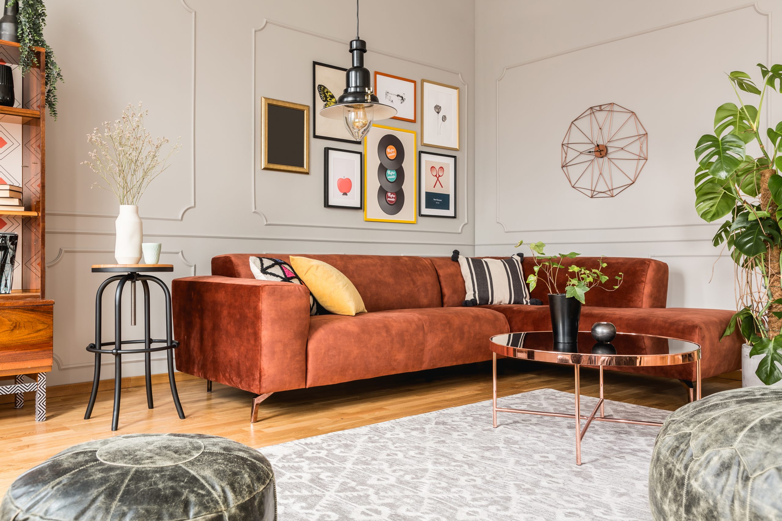 Maximal Eclectic living room interior with comfortable velvet corner sofa with pillows